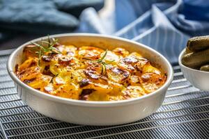 Roasted potatoes in baking dish traditional easten european food titled as france potato photo