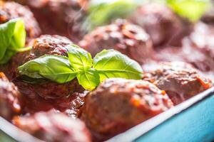 Delisious italian meal meat beef balls with basil in vintage roaster pan. photo