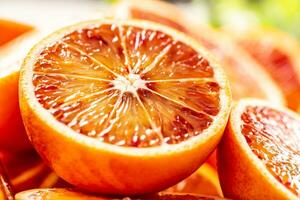 Blood sicilian oranges sliced with fresh melissa - close up photo