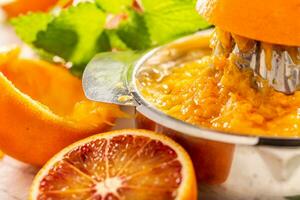 Staniless steel juicer full of orange pulp - close up photo