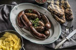 Roasted sausages in pan with rosemary. Traditional european food bratwurst jaternice or jitrnice photo