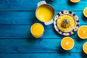 Hand juicer and fresh oranges.Tropical fresh fruits photo