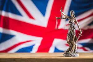 Lady Justice and United Kingdom flag. Symbol of law and justice with UK Flag photo