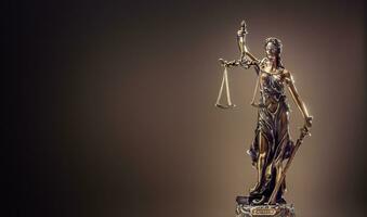 Statute of Justice. Bronze statue Lady Justice holding scales and sword photo