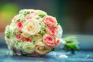 Wedding bouquet.Wedding bouquet with roses on table photo