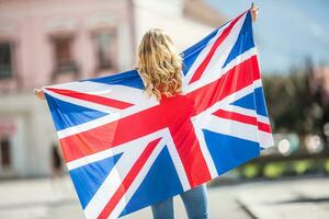 Attractive happy young girl with the flag of the Great Britain photo