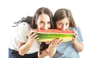 Mom and daughter are eating a huge watermelon - Isolated on wtite photo