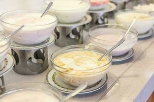 Yogurts in bowls on the buffet table in the hotel restaurant photo