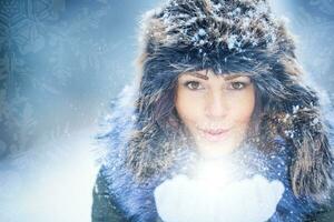 Beautiful smiling young woman in warm clothing. The concept of portrait in winter snowy weather. photo