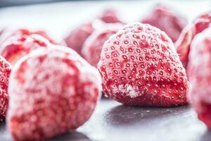 Close-up frozen strawberries covered by frost. photo