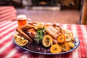 Festive garnished roast duck with apples and red cabbage photo