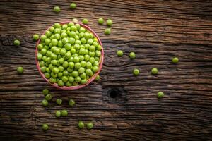 Peas. Fresh bio homemade peas and pods on old oak board. Healthy fresh green vegetable - peas and pods. photo