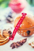 Jingle bell gingerbread cinnamon star anise on table photo