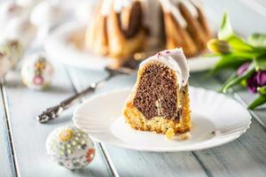 A cut piece of Easter marble cake on a white plate photo