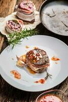 Grilled beef tenderloin steak with chili sauce in white plate photo