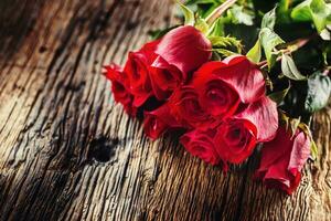 Red Roses. Bouquet of red roses free lying on rustic oak table photo