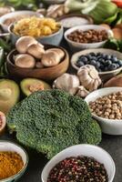 Choice of fresh food and healthy eating focused on broccoli. Vegetables, fruits, legumes and cereals on a concrete table photo