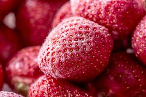 Strawberry. Frozen strawberry covered by frost - closeup photo