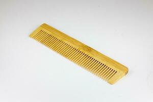 Wooden comb on a white background, isolated, close-up photo