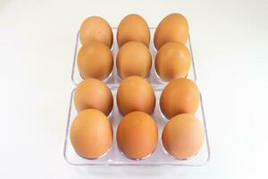 Eggs in a plastic container on a white background, isolated photo