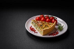 Delicious fresh quiche with broccoli, cheese, spices and herbs cut into pieces photo