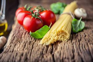 Spaghetti.Spaghetti tomatoes basil olive oil parmesan cheese and mushrooms on very old oak board. Mediterrannean cuisine and ingredients photo