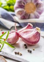 Garlic Cloves and Bulbs with rosemary salt and pepper. photo