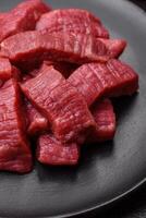 Juicy fresh raw beef meat with salt, spices and herbs photo