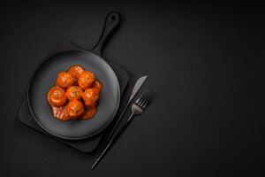 Delicious fresh meatballs in tomato sauce with salt, spices and herbs photo