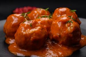 Delicious fresh meatballs in tomato sauce with salt, spices and herbs photo