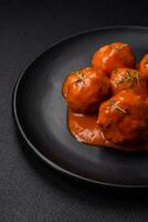 Delicious fresh meatballs in tomato sauce with salt, spices and herbs photo