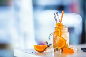 Orange non alcoholic lemonade with levander and ice cubes photo