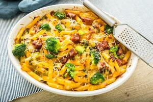 Baked pasta penne with broccoli smoked pork neck mozzarela cheese and othe ingredients photo