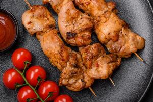 Delicious fresh, juicy chicken or pork kebab on skewers with salt and spices photo