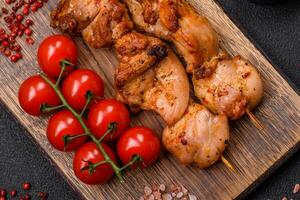 Delicious fresh, juicy chicken or pork kebab on skewers with salt and spices photo