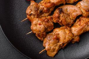 Delicious fresh, juicy chicken or pork kebab on skewers with salt and spices photo