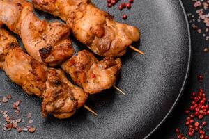 Delicious fresh, juicy chicken or pork kebab on skewers with salt and spices photo