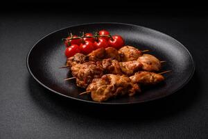 Delicious fresh, juicy chicken or pork kebab on skewers with salt and spices photo