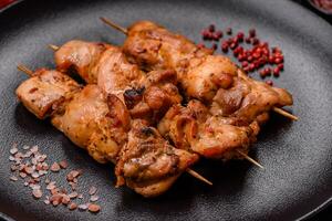 Delicious fresh, juicy chicken or pork kebab on skewers with salt and spices photo