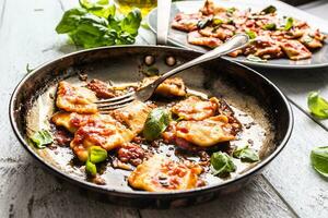 Italian or mediterranean food pasta ravioli of tomato sauce. photo