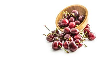 Sweet ripe cherries in bowl isolated on white background photo