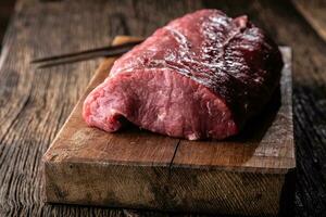 High rib eye steak whole on a wooden board -Close up photo