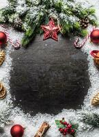 Christmas star spruce branches and decorations on snow. photo