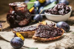 Breakfast from homemade plum jam bread and ripe plums. photo