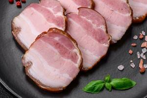 Delicious smoked bacon with salt, spices and herbs photo