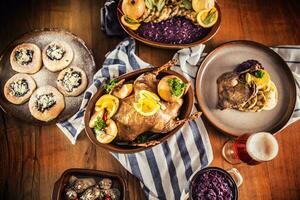 Top of view roasted christmas duck red cabbage dumplings liver draft beer and baked buns photo