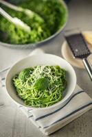 Spaghetti. Green spaghetti with spinach and parmesan. Italian and mediterranean cuisine photo