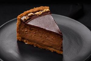 Delicious, fresh, sweet chocolate cake with nuts cut into slices photo