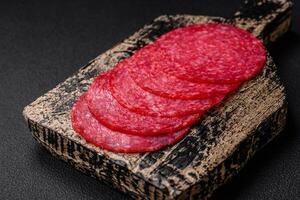 Delicious smoked salami sausage with salt, spices and herbs photo