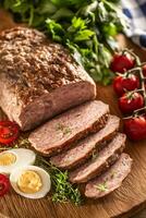 Homemade ground meatloaf with eggs tomatoes celery herbs and thyme photo